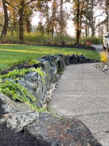 Retaining wall managing water on a sloped yard in Oregon