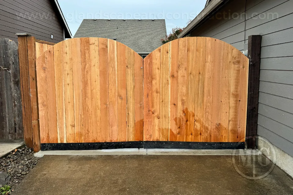 Double wood gate spanning the passage between two homes