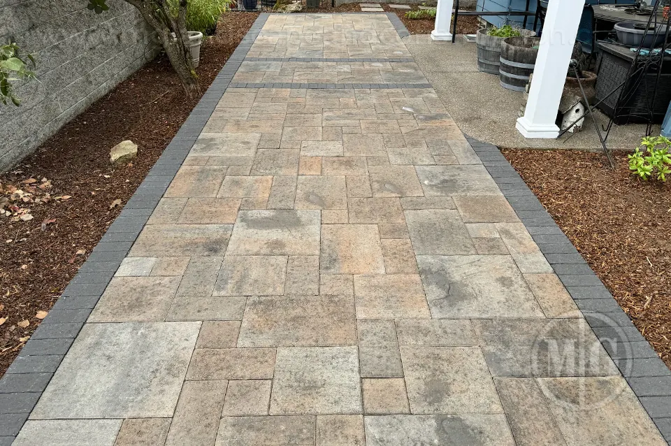 Rectangular paver patio with mixed stone tones and a contrasting border