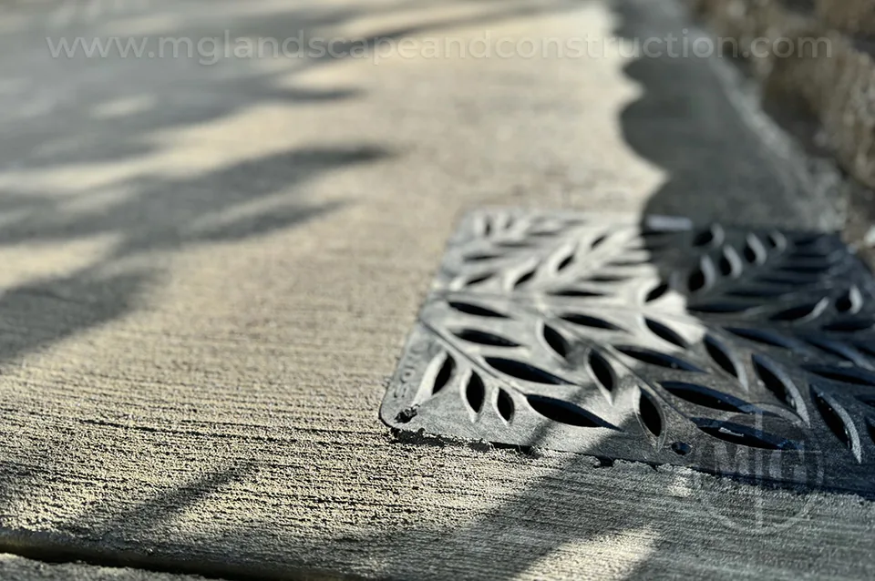 Round surface drain grate set into a paved area